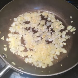 Onions and garlic cooking in wine