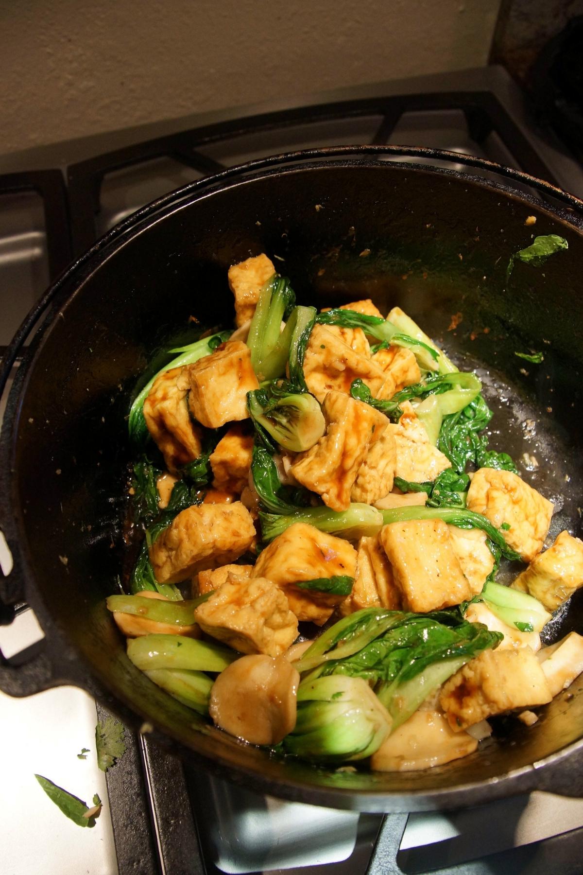 tofu and swiss chard in a stir fry pan