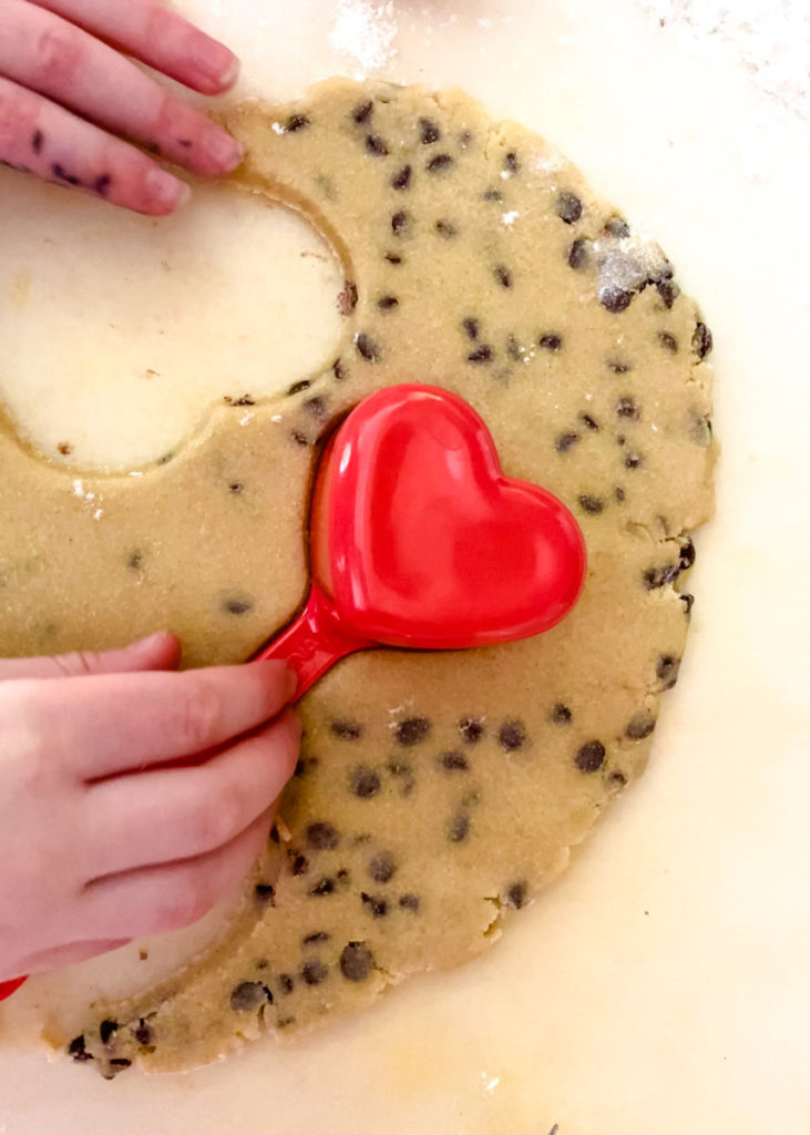cutting cookie dough into heart shapes