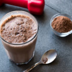 a chocolate smoothie shake on a counter with a spoon