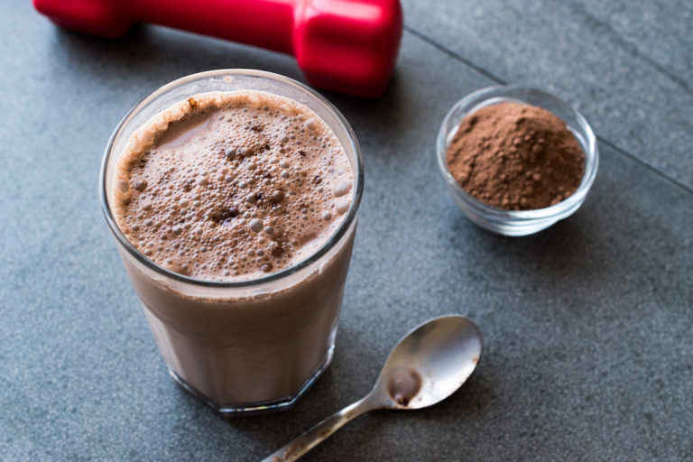 a chocolate smoothie shake on a counter with a spoon
