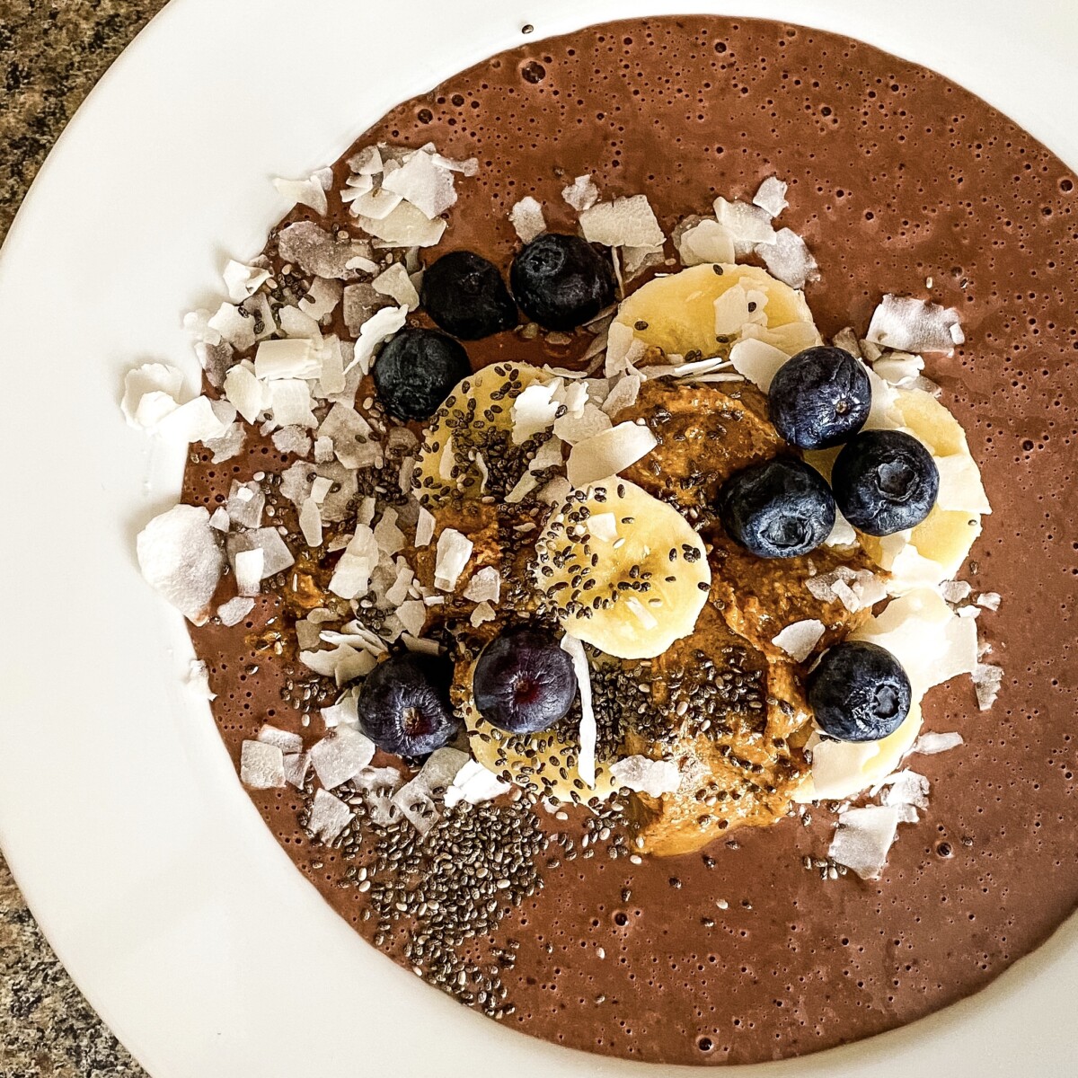 chocolate protein smoothie bowl with toppings