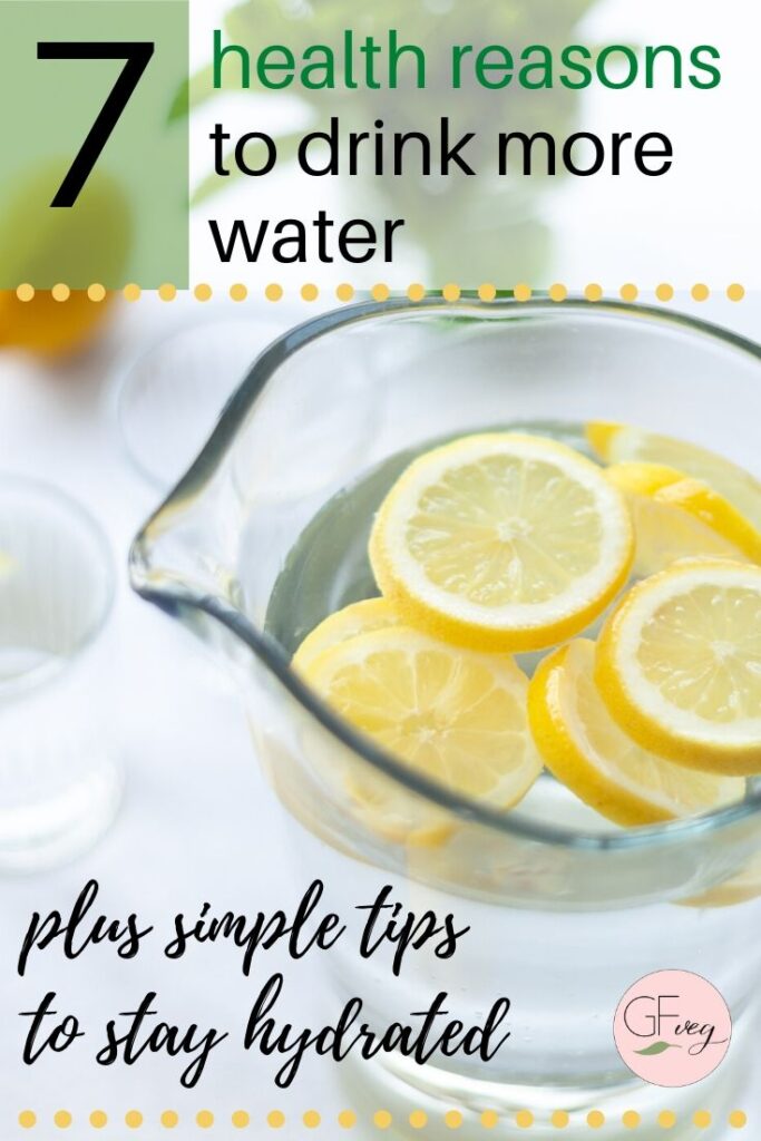 pitcher of water with lemons and text overlay saying "7 health reasons to drink more water"