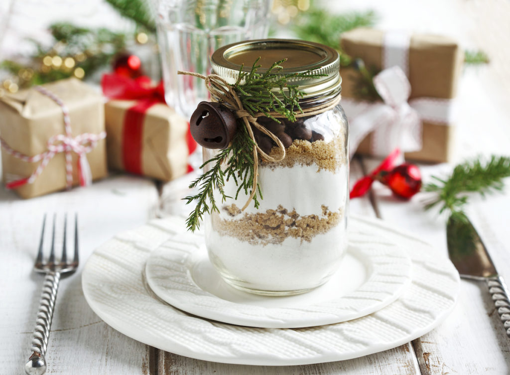 a jar of cookie baking mix wrapped as a gift on a holiday table